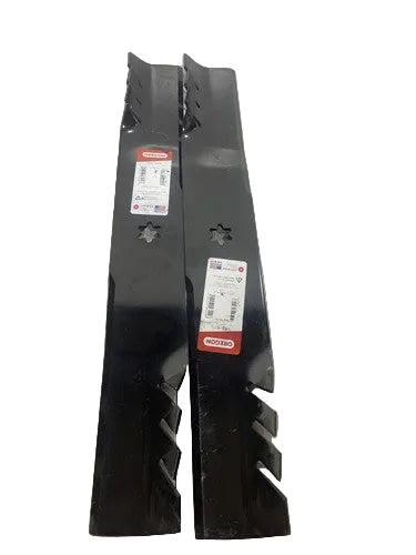 Two black metal blades with visible branding on a gray surface